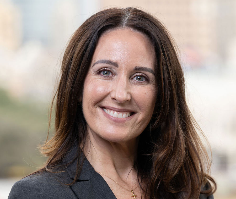 Keri Corbin in color photo smiles at the camera.