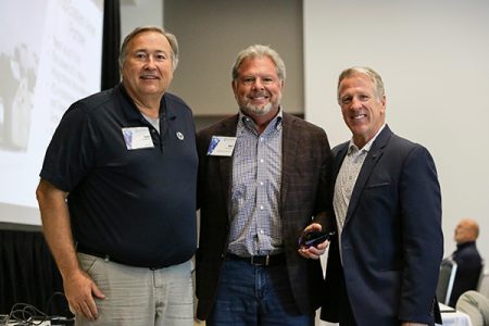 Three men smile for the camera, celebrating DecisionPoint's HP Reseller of the Year award.