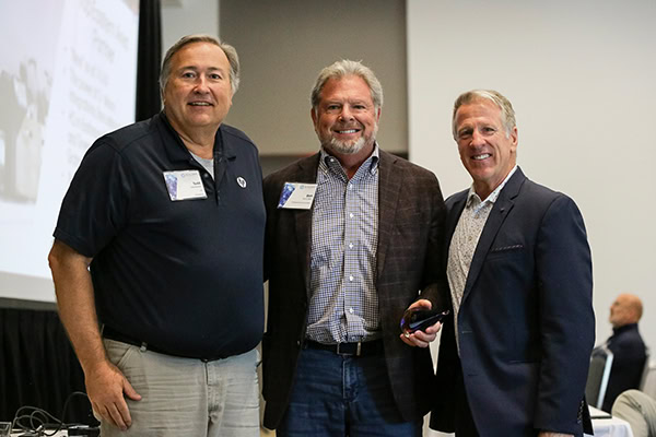Three men smile for the camera, celebrating DecisionPoint's HP Reseller of the Year award.