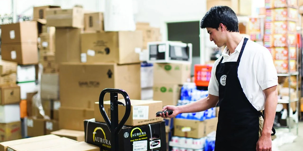 Employee uses a handheld scanner to scan barcodes.