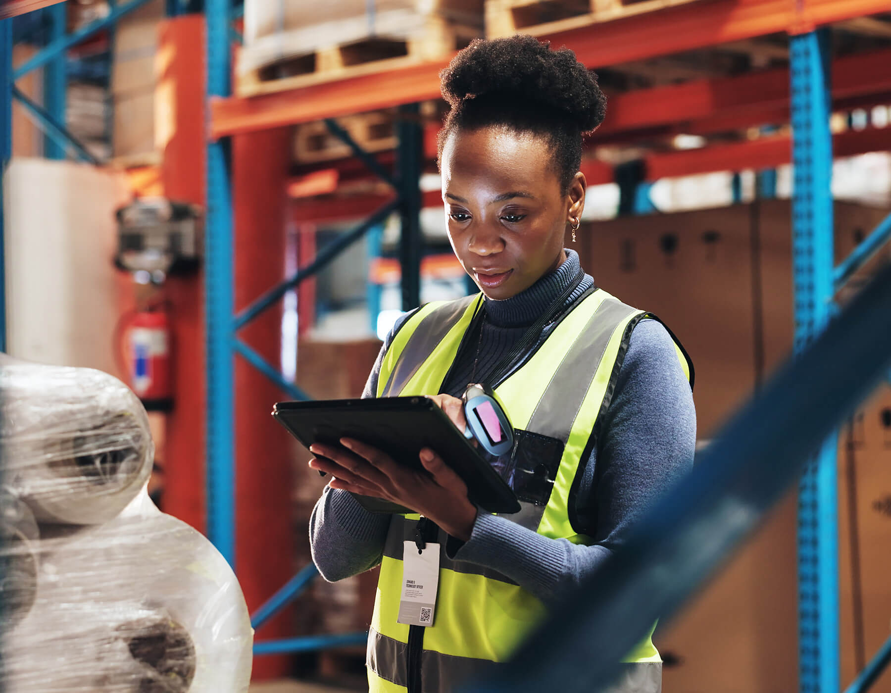 A warehouse worker uses RFID and Automation tools to track assets and inventory.
