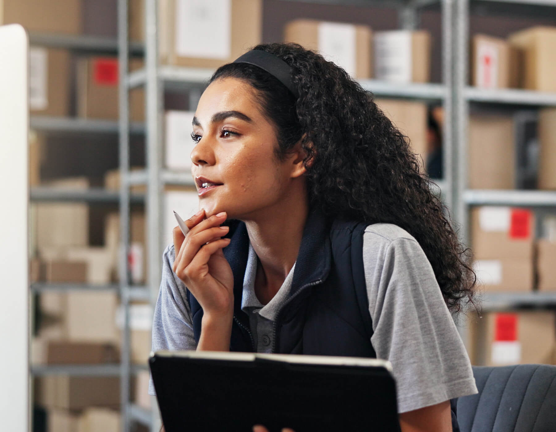 Woman ponders enterprise mobility in her warehouse.