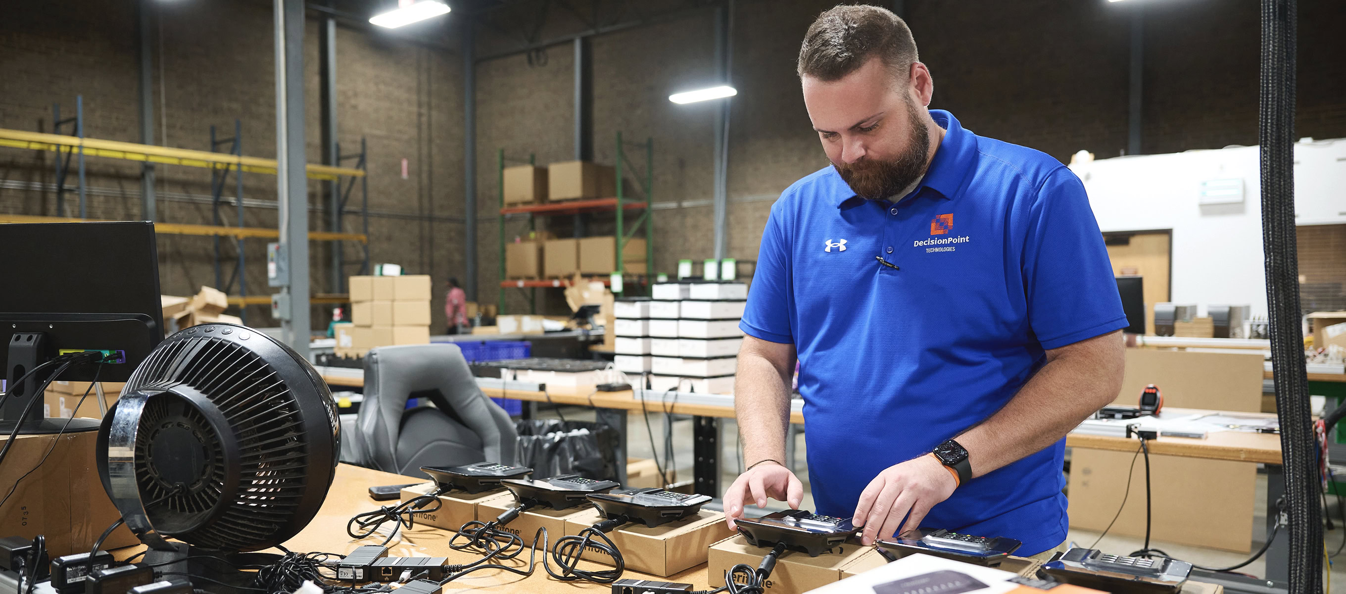 DecisionPoint employee programs several point of sale devices.