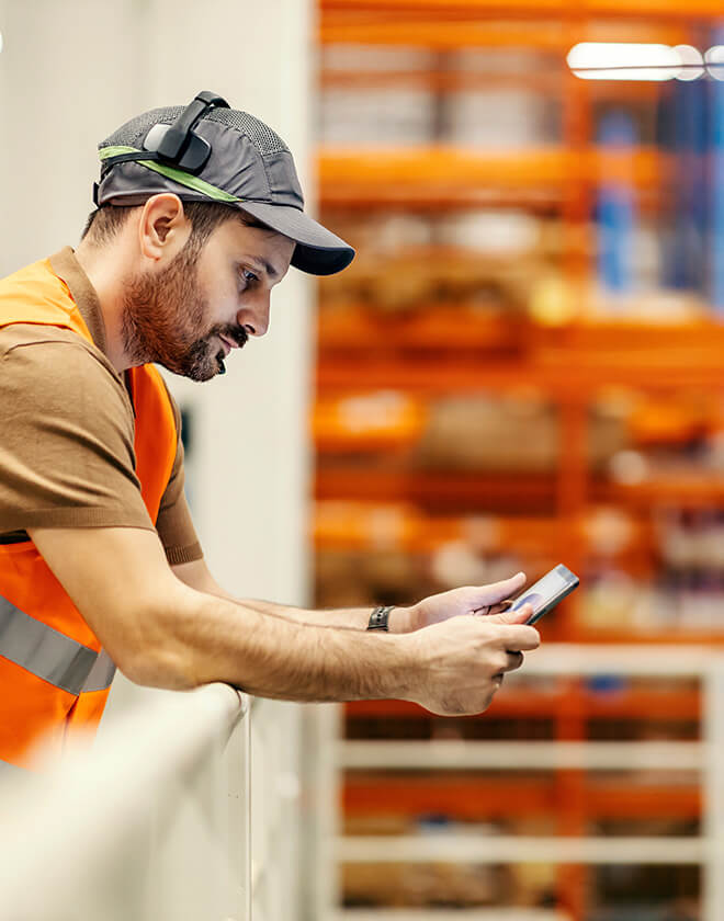 Worker uses a robust set of platforms on a tablet in a warehouse environment.