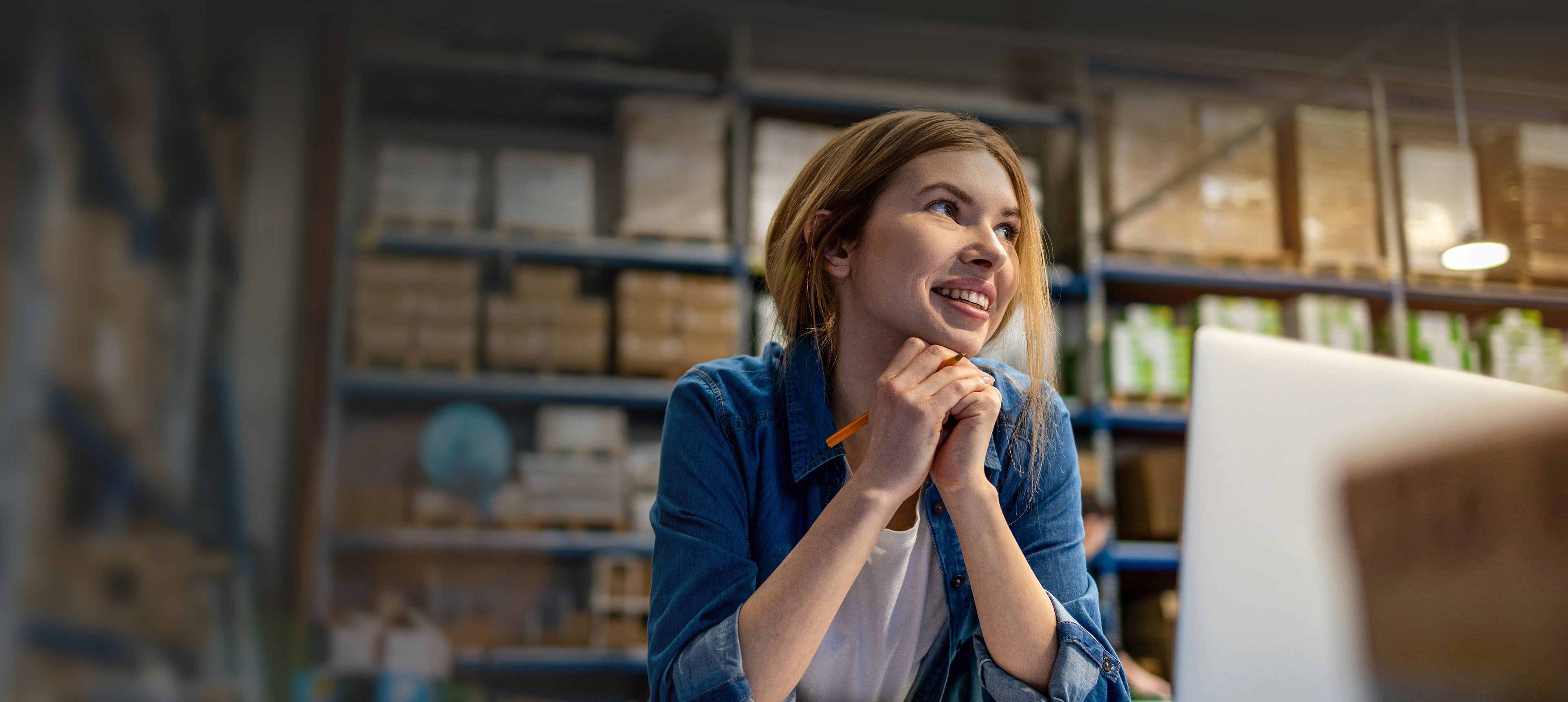 Smiling employee reads DecisionPoint Resources on her laptop.