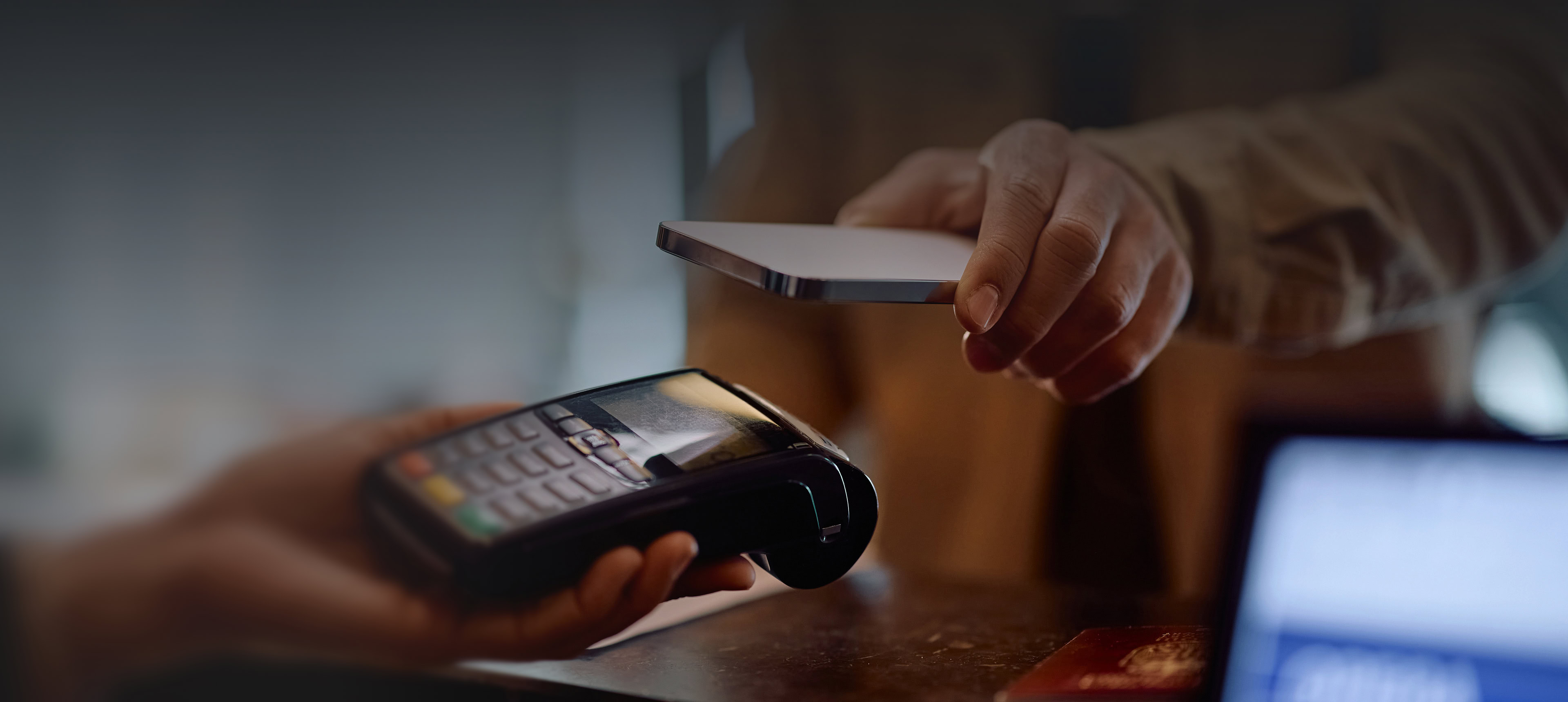 Two people show a Solutions that allows mobile devices to exchange data with handheld scanners for easy data transfer.