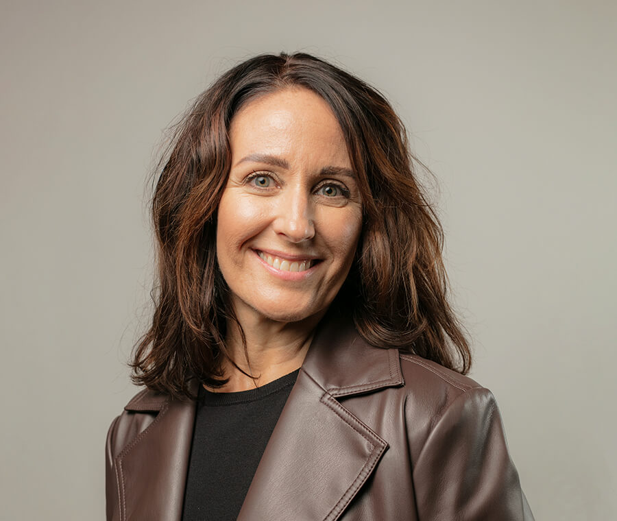 Keri Corbin in color photo smiles at the camera.