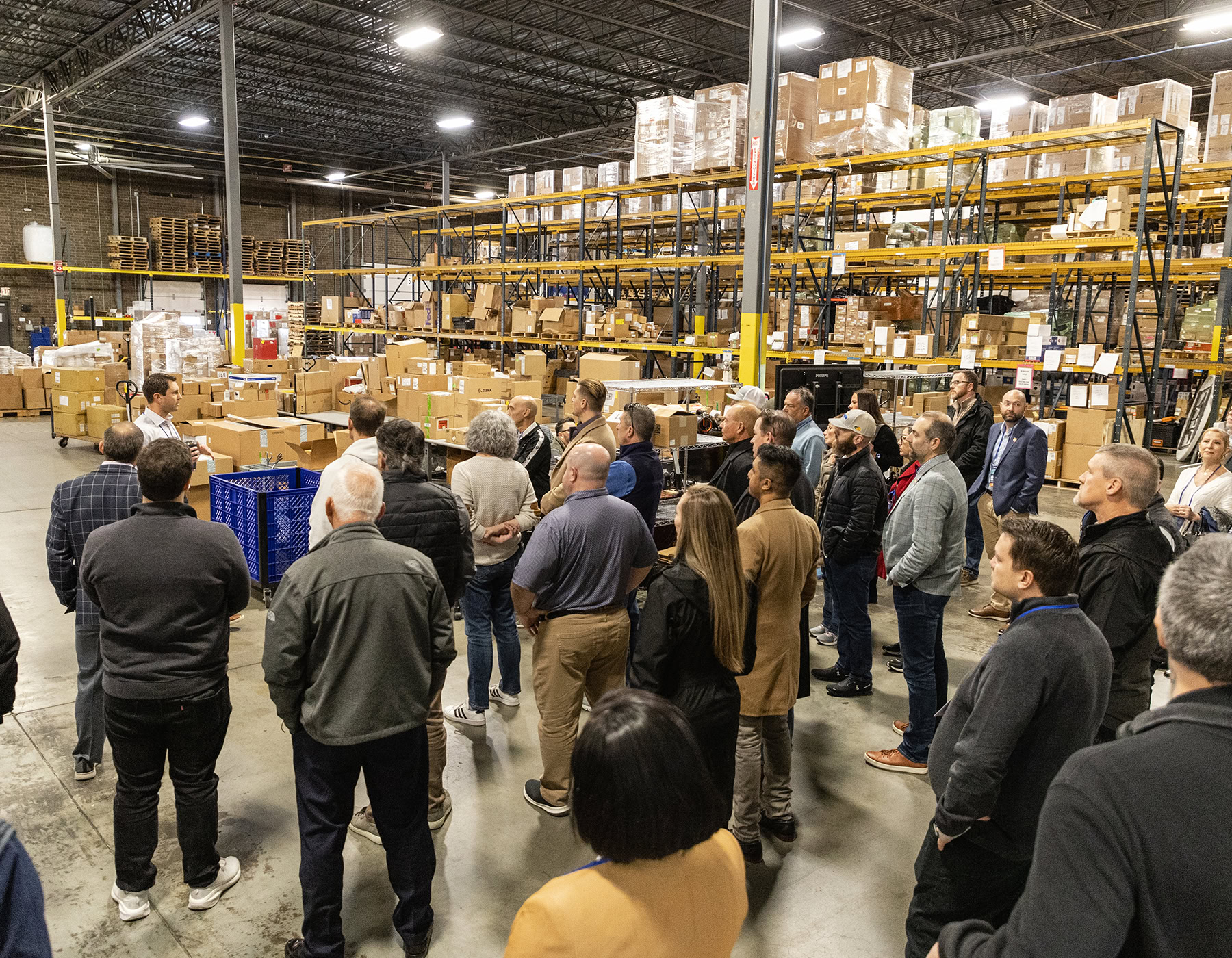 DecisionPoint employee talks to a warehouse full of people about their upcoming improved visibility and tool integration.