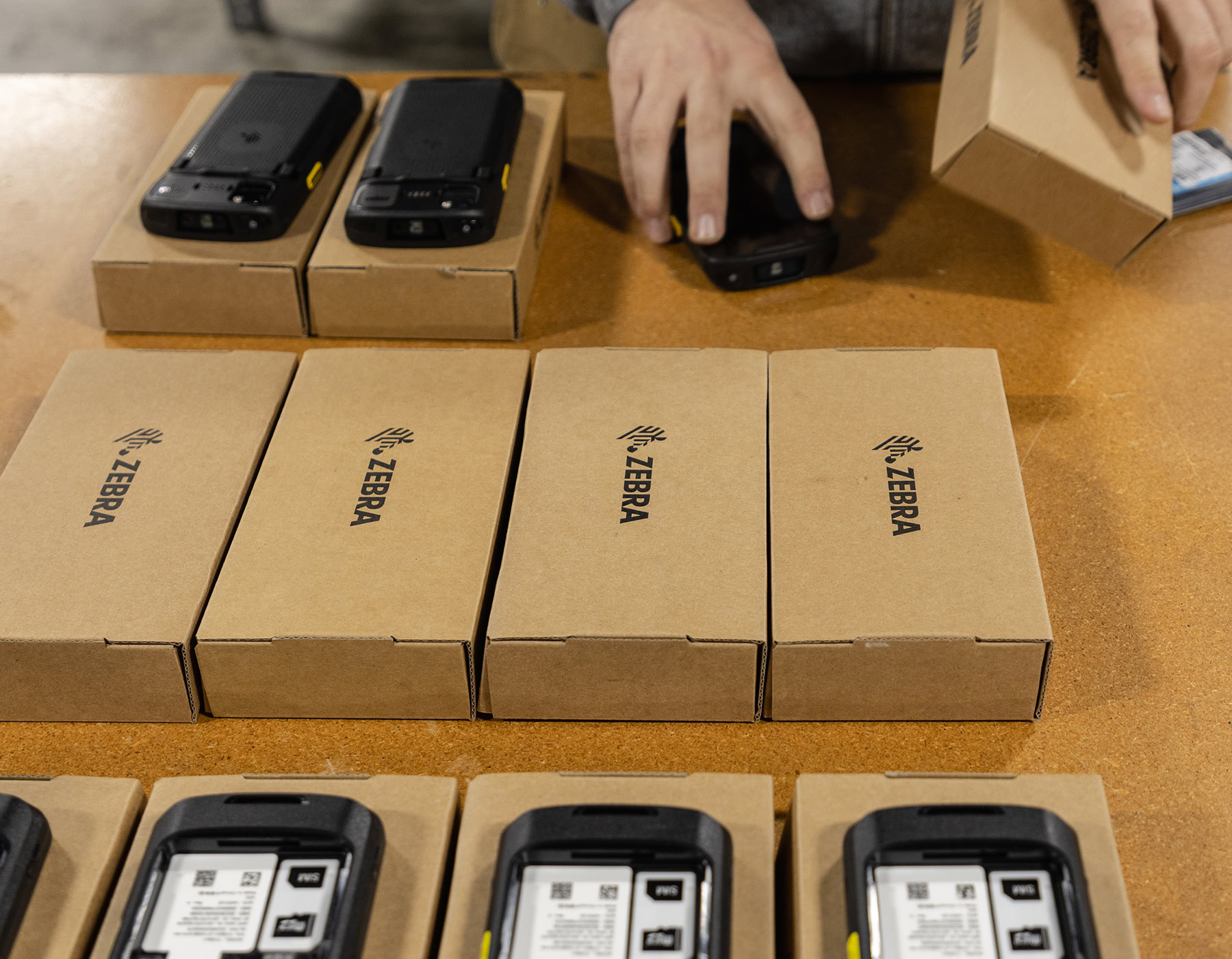 Mobile device rental products being removed from the boxes during preparation to send them out.