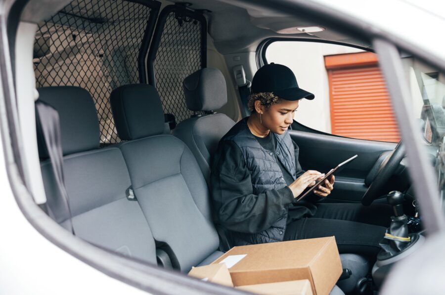 Delivery driver checking an asset update on a tablet, a real-world asset visibility metric in action