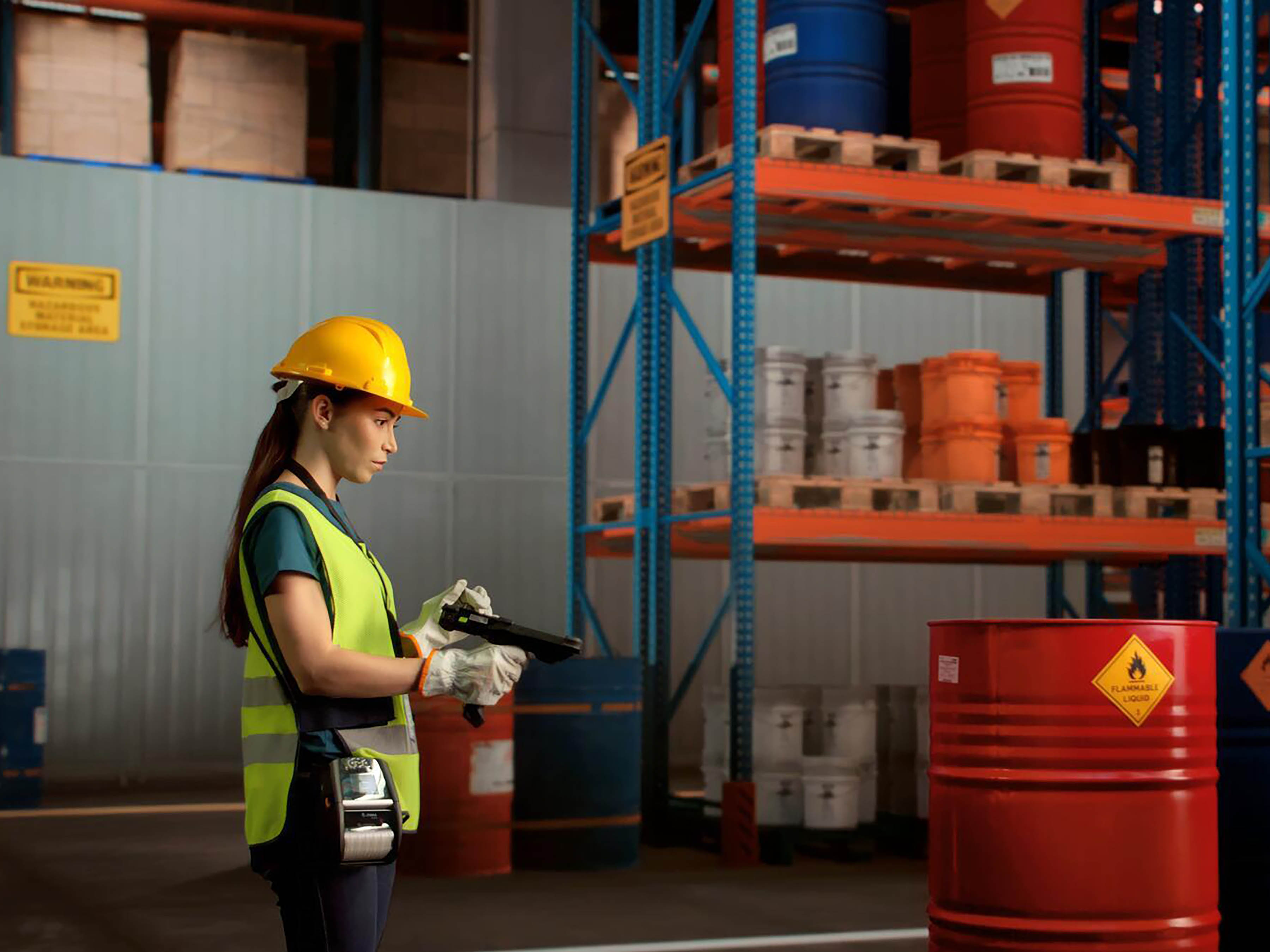 worker scanning a hazardous materials label in a warehouse.