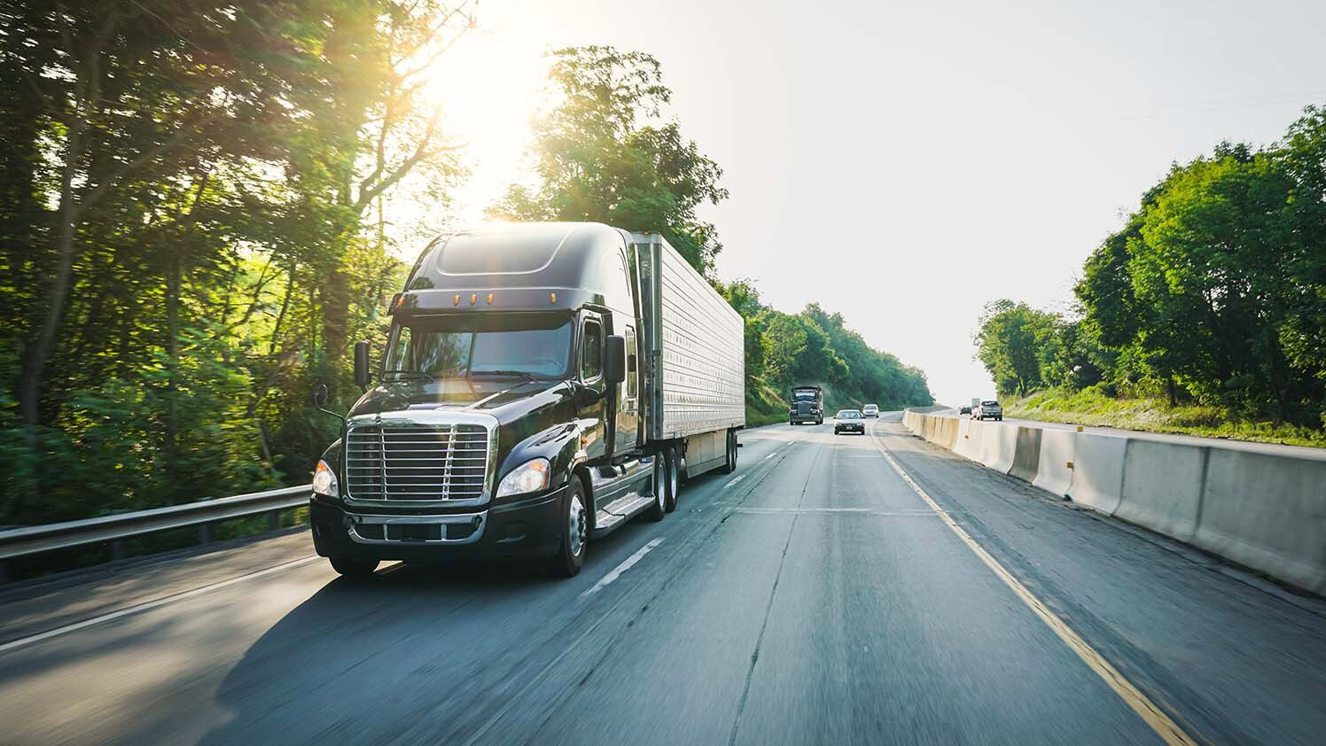 Fleet intelligence in action as a tractor-trailer travels on a highway, supporting safer routing, uptime, and operational decisions.